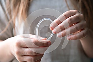 Woman`s hand holding a birth control ring, vaginal ring for contraceptive photo