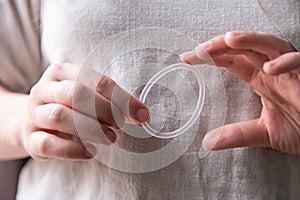 Woman`s hand holding a birth control ring, vaginal ring for contraceptive photo