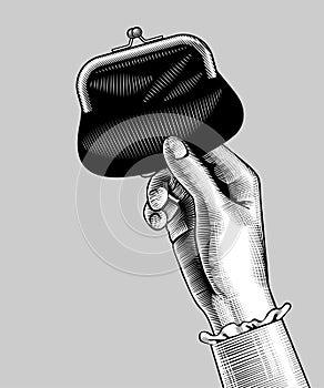 Woman`s hand holding a black wallet with money