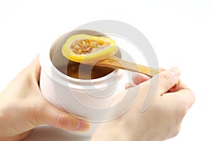 Woman`s hand holding cup of tea with lemon