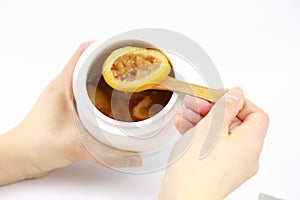 Woman`s hand holding cup of tea with lemon
