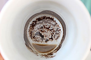 Woman`s hand holding empty cup of coffee to tell fortunes. Drawing of coffee grounds predicts future