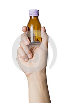 Woman`s hand holding empty small brown medicine bottle liquids transparent on white background