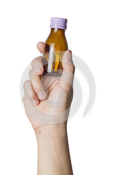 Woman`s hand holding empty small brown medicine bottle liquids transparent on white background