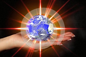 Woman's hand holding an exploding earth