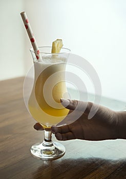 Woman`s hand holding glass of coctail