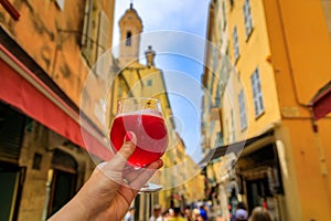 Woman s hand with a glass of raspberry Lambic ale at a restaurant in Nice France photo