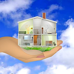 Woman's hand holding a house cut with interiors