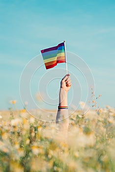 Woman`s hand holding an lgtb flag