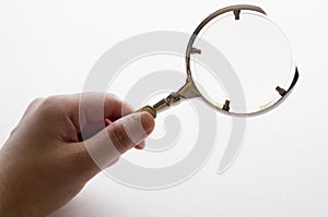 Woman's hand holding magnifying glass