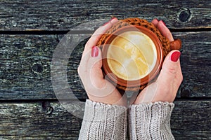 Woman's hand holding a mug of coffee