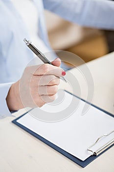 Woman's hand holding a pen photo