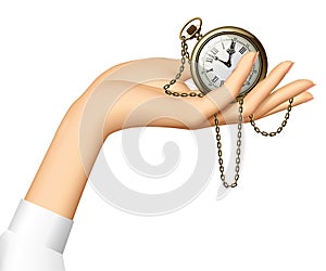 Woman`s hand holding a retro pocket watch with chainlet