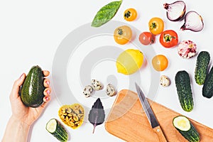 Woman's hand holding ripe avocado