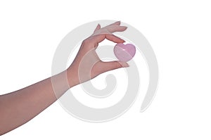 Woman's hand holding Rose Quartz heart