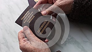 Woman`s hand holding russian pension certificate.