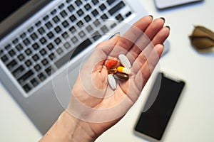 Woman`s hand holding vitamin pills