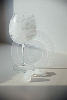 A woman's hand holds a glass with ice