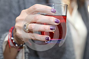 Woman's hand that holds the glass for the toast