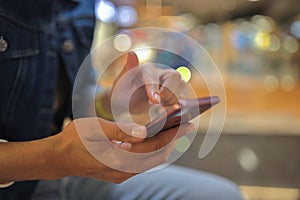 Woman`s hand holds smartphone and moves her finger across screen.