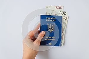 Woman& x27;s hand holds Ukrainian biometric passport with payment from United Nations to refugees from Ukraine - 710 PLN.