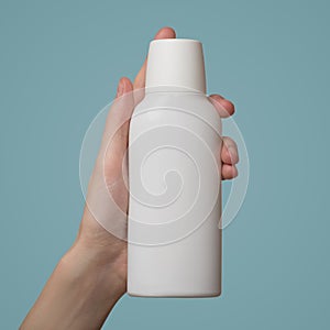 Woman`s hand holds a white bottle of shampoo. Template blank copyspace. Blue background