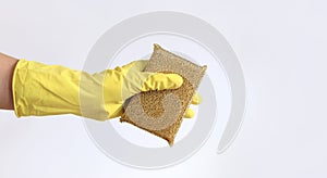 A woman's hand in a latex glove holds a sponge-scraper for washing Teflon surfaces