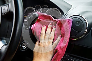 Woman's hand with microfiber cloth polishing of a car photo