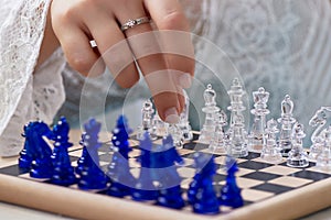 A woman`s hand moves the pieces on the chessboard. Finding solutions, brain activity.The development of the mind.