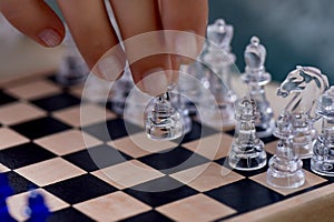 A woman`s hand moves the pieces on the chessboard. Finding solutions, brain activity.The development of the mind.