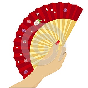 Woman`s hand with open chinese red fan on white background