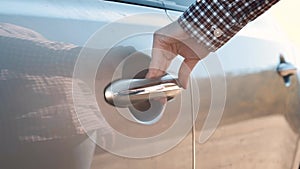 Woman's hand opening car door