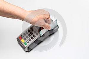 Woman`s hand passing credit card by a dataphone, card reader to charge in time of sales