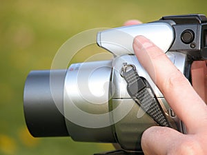 Woman's hand with photo camera