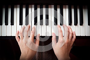 Woman's hand playing piano.