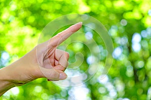 Woman's hand with pointing finger.