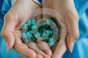 Woman`s hand pours the medicine pills