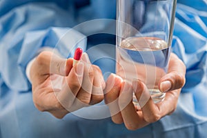 Woman`s hand pours the medicine pills