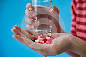 Woman`s hand pours the medicine pills