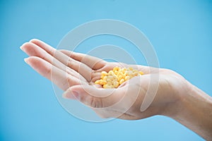 Woman`s hand pours the medicine pills