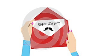 Woman`s hand putting a card with text THANK YOU DAD in red envelope