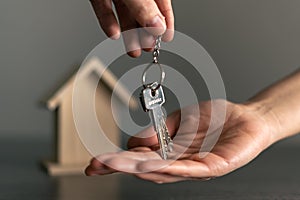 Woman's hand receiving the keys of her new house owned or rented.