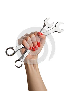 Woman& x27;s hand with a red manicure and a wrench.
