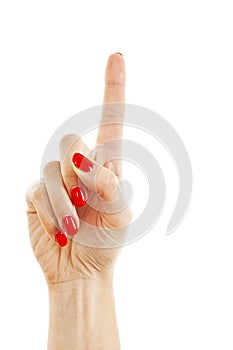 Woman's hand with red nails pointing with index finger