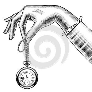 Woman`s hand with a retro pocket watch