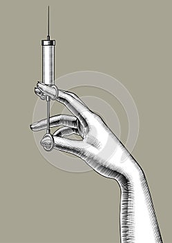 Woman`s hand with a retro syringe