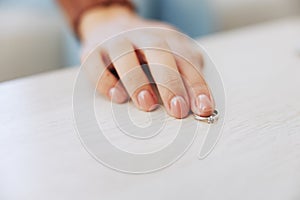 Woman& x27;s hand with ring close-up on table, divorce and loss of partner, passing