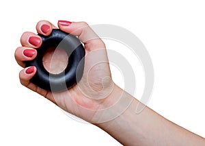 Woman`s hand with rubber ring used as hand expander hand gripper. Hand grip strengthening tool.