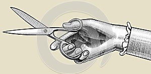 Woman`s hand with scissors