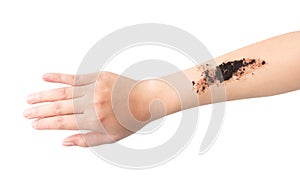 Woman`s hand with scrub coffee grounds on skin hand and arm, bea